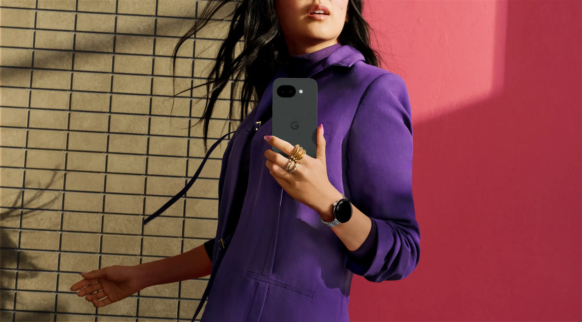 Uma mulher a segurar um Pixel 10a na cor Obsidiana.